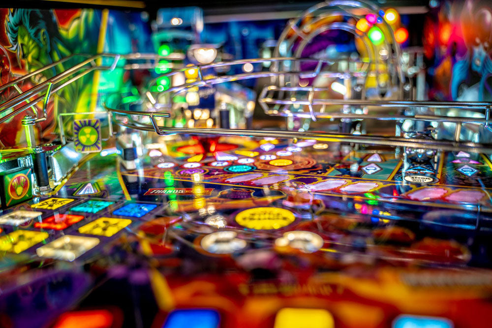 Close-up of a colorful pinball machine with vibrant lights and details.