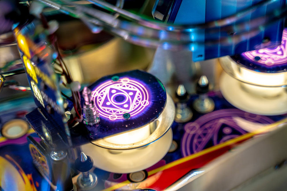 Close-up of a pinball machine with glowing components
