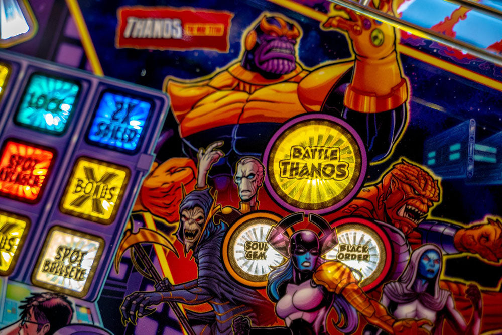 Pinball machine with 'Thanos' and 'Battle Thanos' branding, featuring superhero characters.