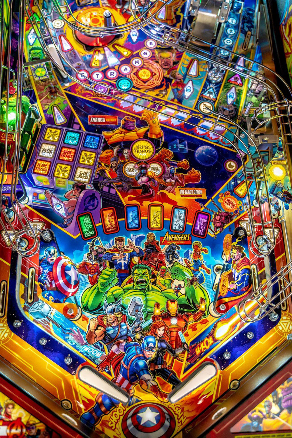 Colorful pinball machine with superhero characters and vibrant graphics
