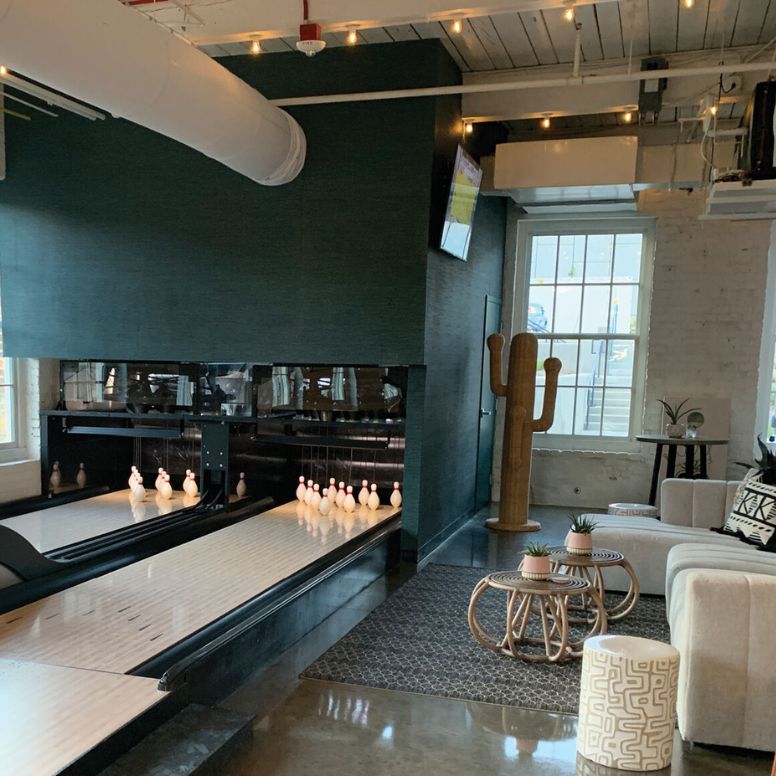 Interior view of a modern bowling alley with duckpin bowling lanes. Classic interior with a boho vibe.