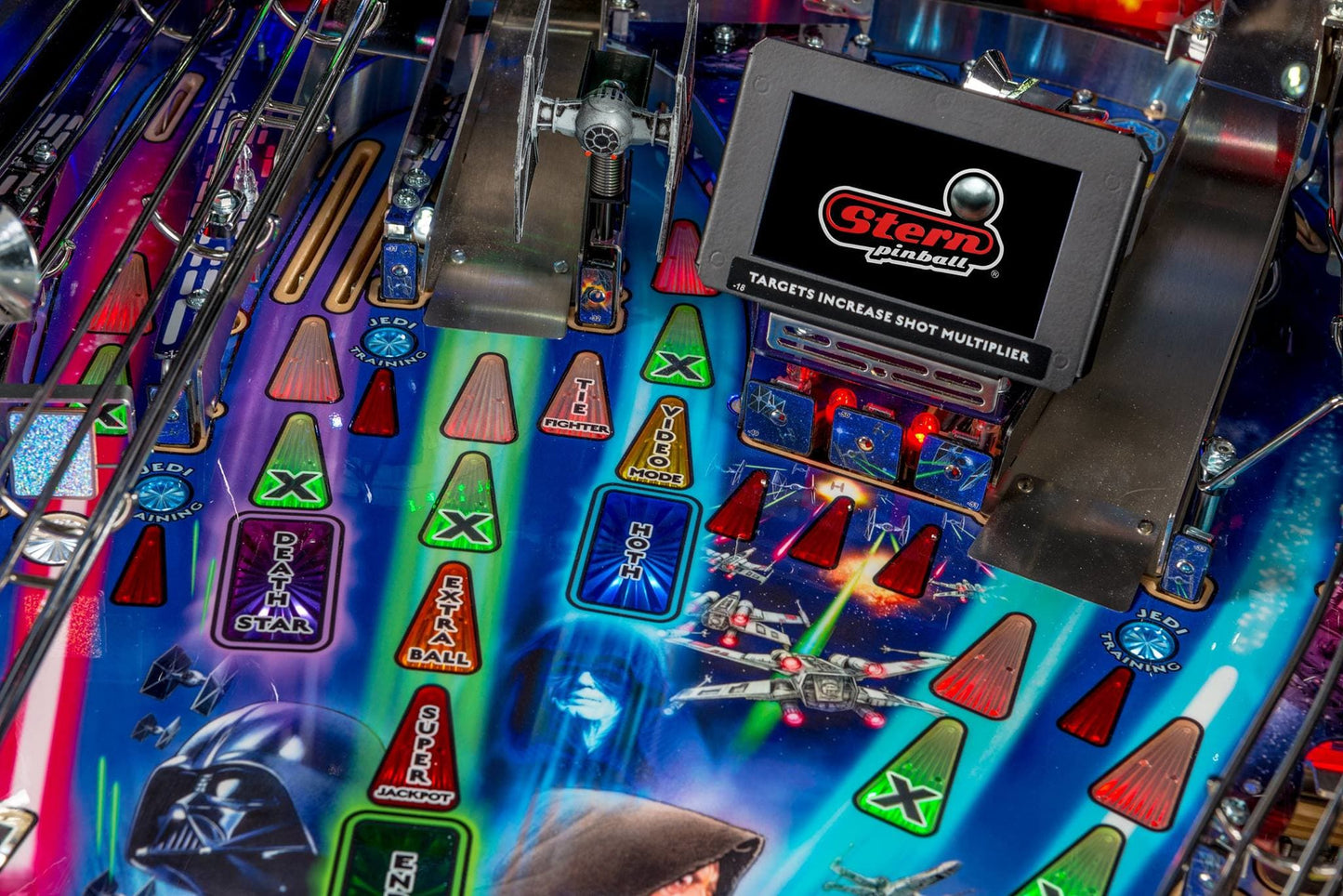Close-up of a pinball machine with colorful playfield and control panel.