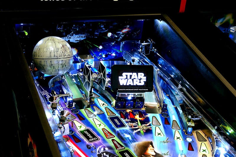 Pinball machine with Star Wars theme featuring the Death Star and other characters.