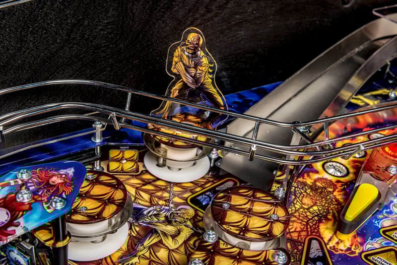 Close-up of a pinball machine with detailed artwork and vibrant colors.