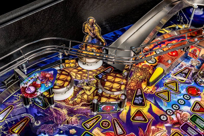 Close-up of a pinball machine with vibrant colors and detailed design.