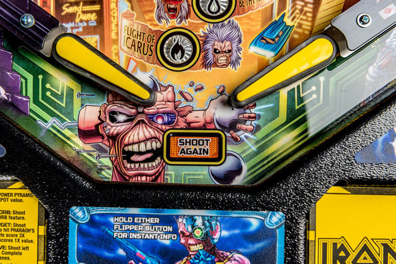 Close-up of a pinball machine with colorful artwork and text.