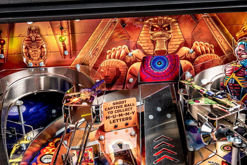 Close-up of a pinball machine with detailed artwork and components.