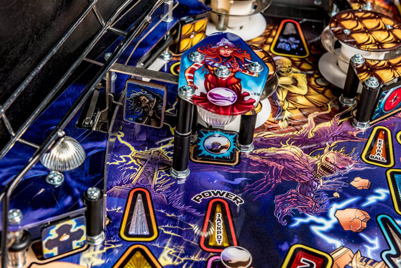 Close-up of a pinball machine with vibrant colors and detailed artwork.