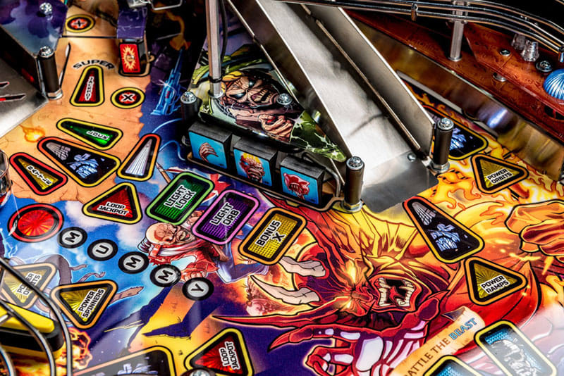 Close-up of a colorful pinball machine with various symbols and designs.