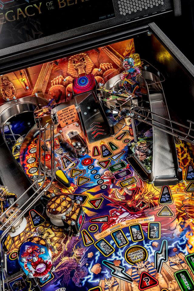 Close-up of a colorful pinball machine with detailed artwork and playfield.