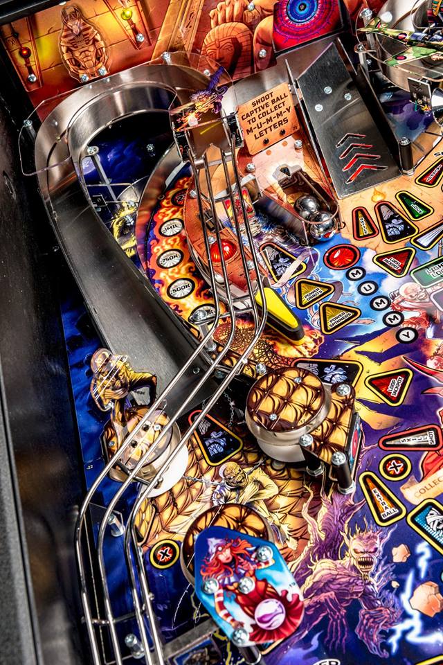 Close-up of a colorful pinball machine with intricate details and vibrant graphics.