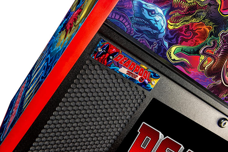 Close-up of a Deadpool-themed pinball machine with colorful graphics and a Deadpool logo.