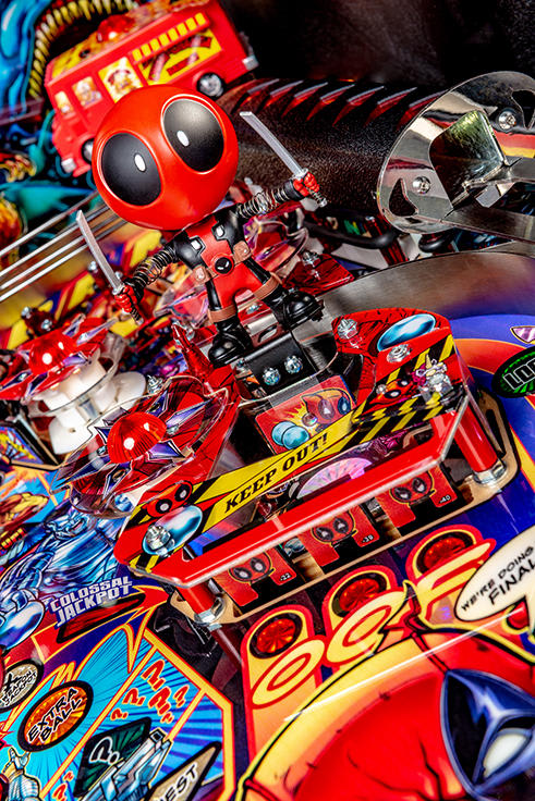 Close-up of a colorful pinball machine with detailed artwork and characters.