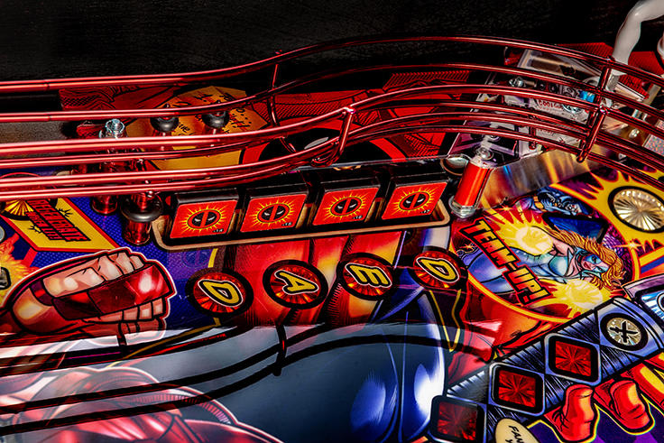 Close-up of a colorful pinball machine with vibrant graphics and bright lights.