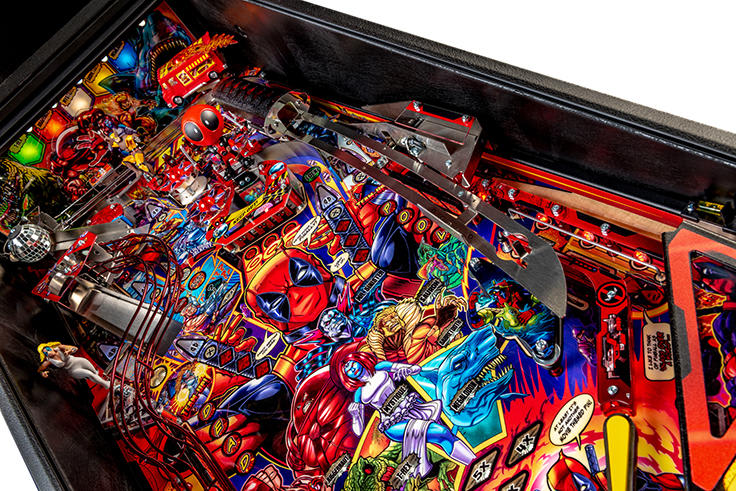 Close-up of a colorful pinball machine with various characters and elements.