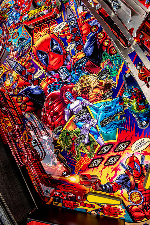 Colorful Deadpool pinball machine with various characters and designs. 