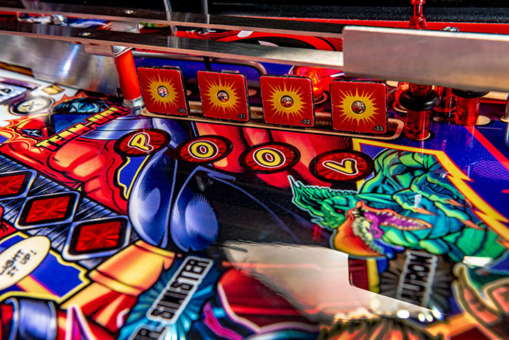Close-up of a colorful pinball machine with 'Pool' and 'Sinister' text.