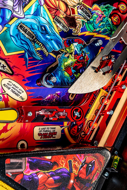 Close-up of a colorful pinball machine with various characters and graphics.