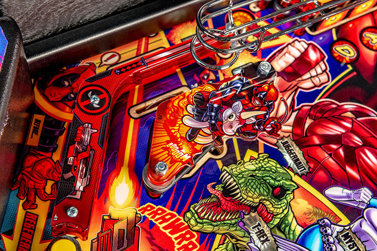 Close-up of a colorful pinball machine with various characters and elements.