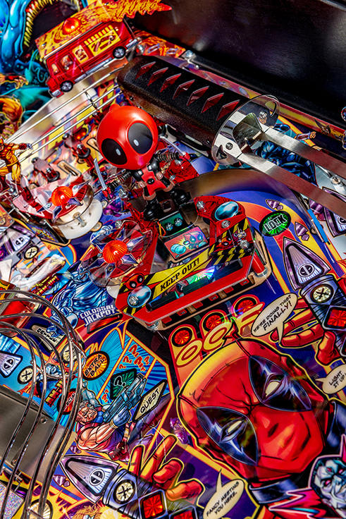 Close-up of a colorful pinball machine with detailed artwork and vibrant colors.