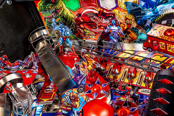 Close-up of a colorful pinball machine with various figures and lights.