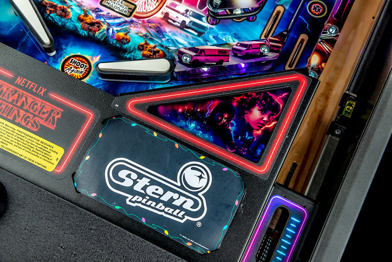 Pinball machine with 'Stranger Things' and Stern Pinball branding.