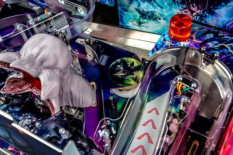 Close-up of a colorful pinball machine with intricate details and vibrant colors.