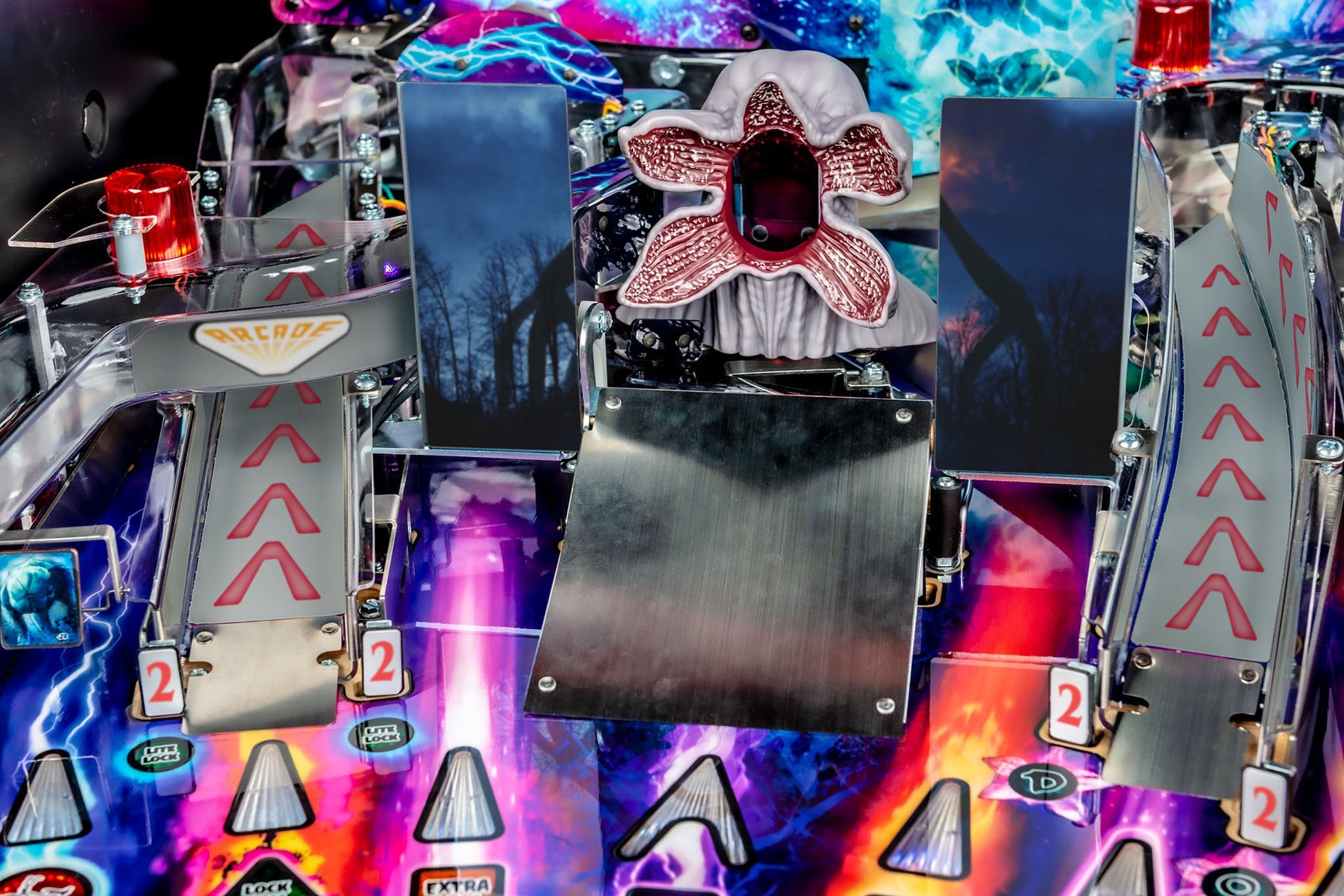 Close-up of a colorful pinball machine with intricate details and vibrant lights.