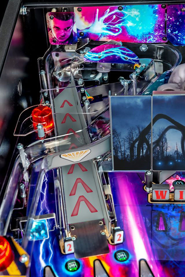 Close-up of a colorful pinball machine with vibrant graphics and mechanical components.