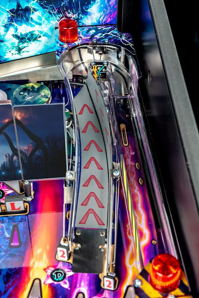 Close-up of a colorful pinball machine with vibrant graphics and mechanical details.