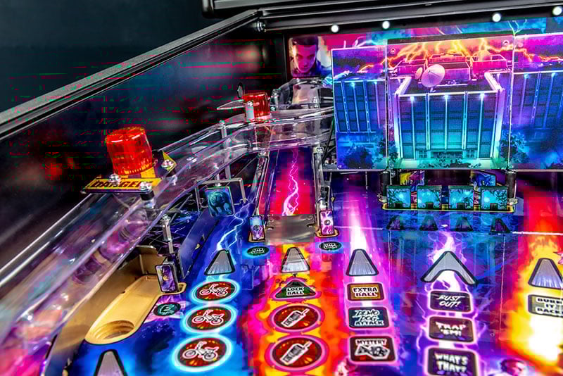 Close-up of a colorful pinball machine with vibrant lights and details.