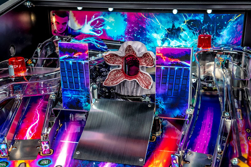 Close-up of a colorful pinball machine with vibrant lights and details.