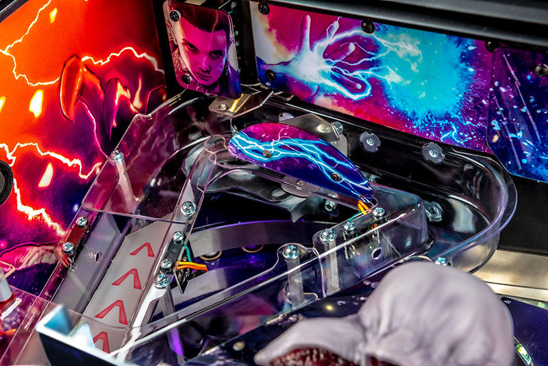 Close-up of a pinball machine with vibrant neon lights and a colorful display.