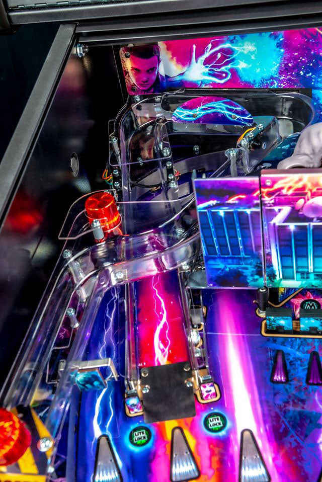 Close-up of a colorful pinball machine with vibrant graphics and lights.