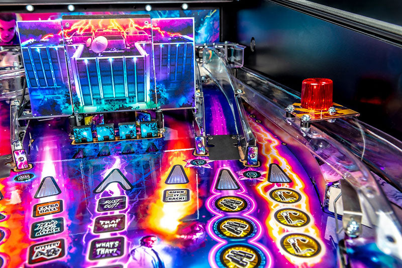 Close-up of a colorful pinball machine with vibrant lights and details.