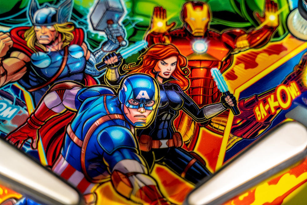 Close-up of a pinball machine with superhero characters including Captain America, Iron Man, and Thor.