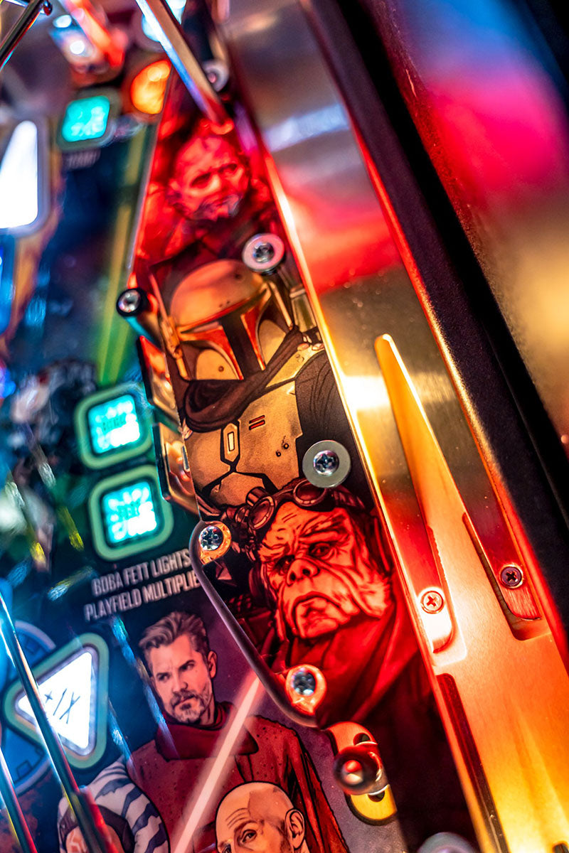 Close-up of a pinball machine with colorful graphics and characters.