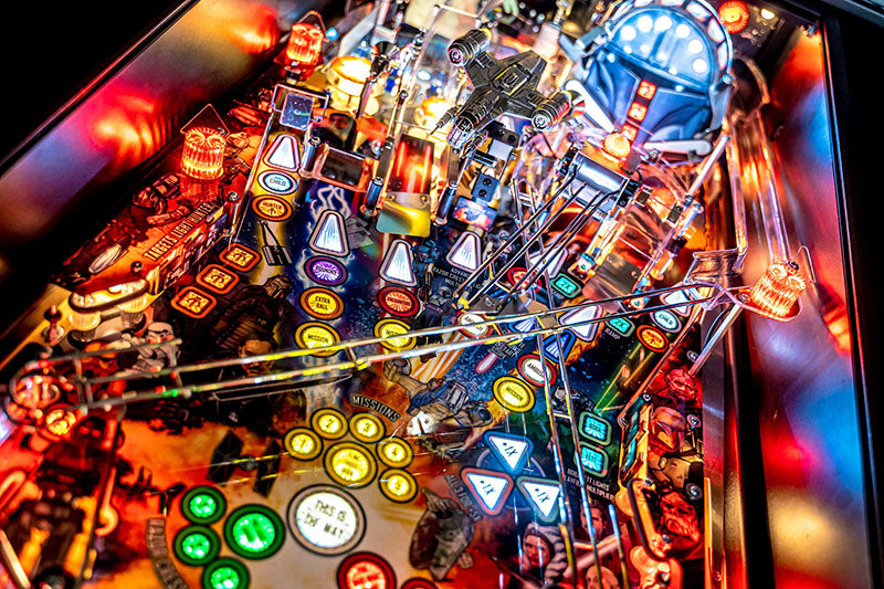 Close-up of a pinball machine with colorful lights and details