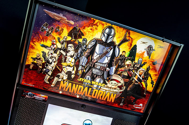Pinball machine with 'The Mandalorian' themed display on a dark background