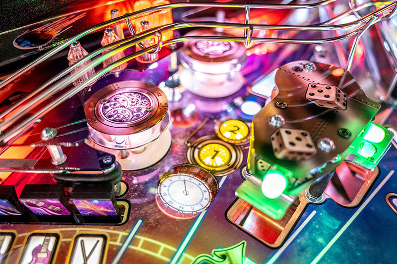 Close-up of a colourful pinball machine with various components.