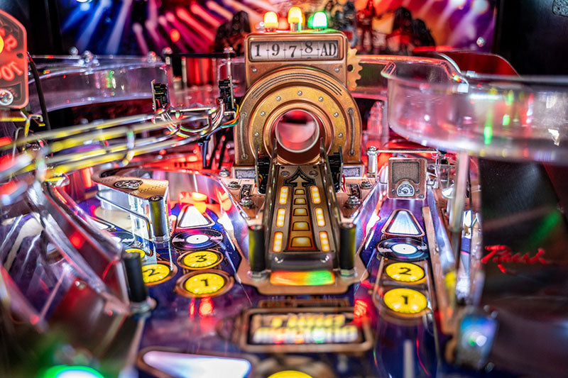 Close-up of a pinball machine with colou
rful lights and buttons.