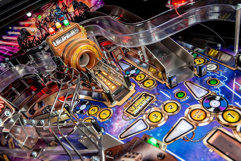 Close-up of a pinball machine with colourful playfield and various components.