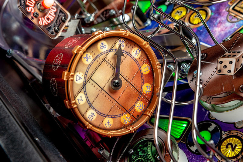 Close-up of a pinball machine with a detailed clock component