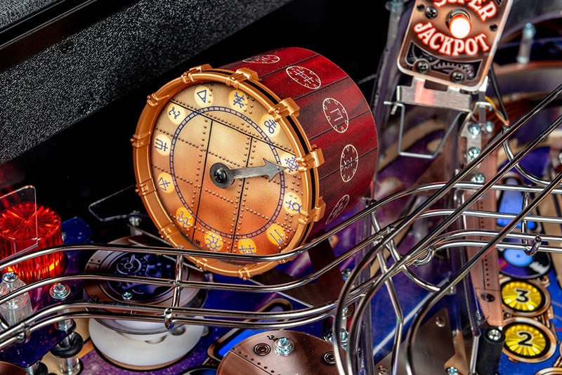 Close-up of a pinball machine with a detailed clock and vintage-style design.