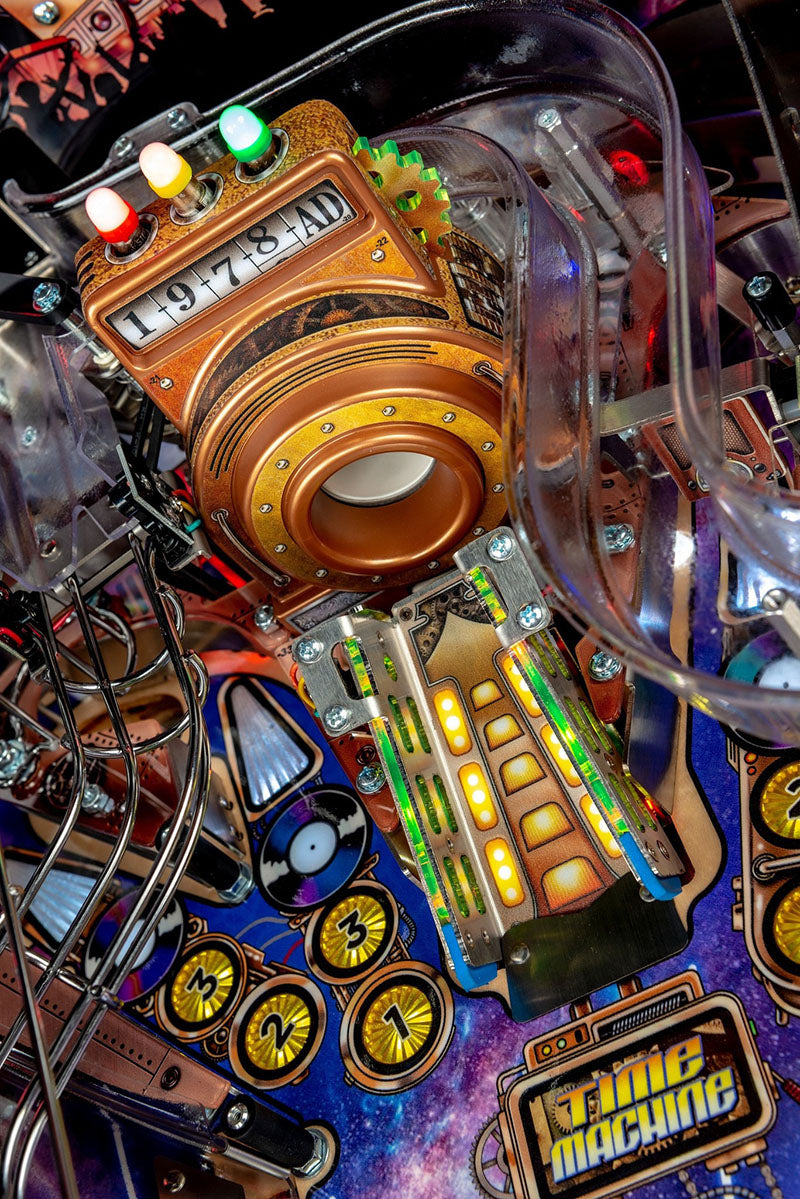 Close-up of a pinball machine with colourful components and 'Time Machine' label.