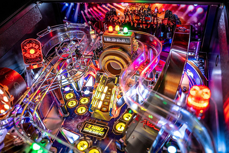 Close-up of a pinball machine with colourful lights and components.