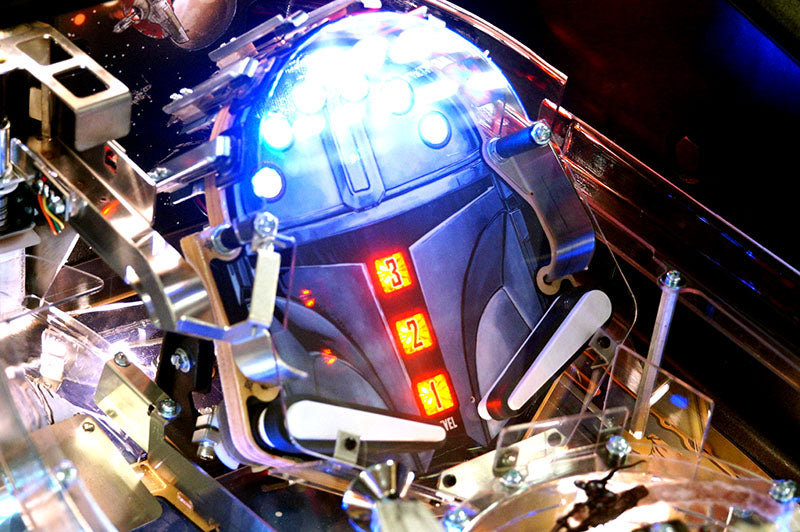 Close-up of a pinball machine with a robot figure on top