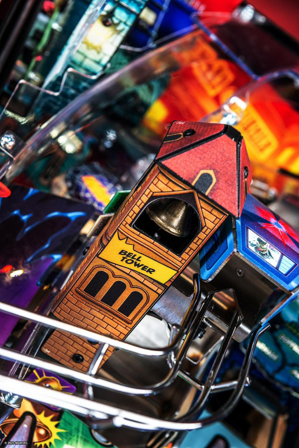 Close-up of a pinball machine component with 'Bell Tower' label