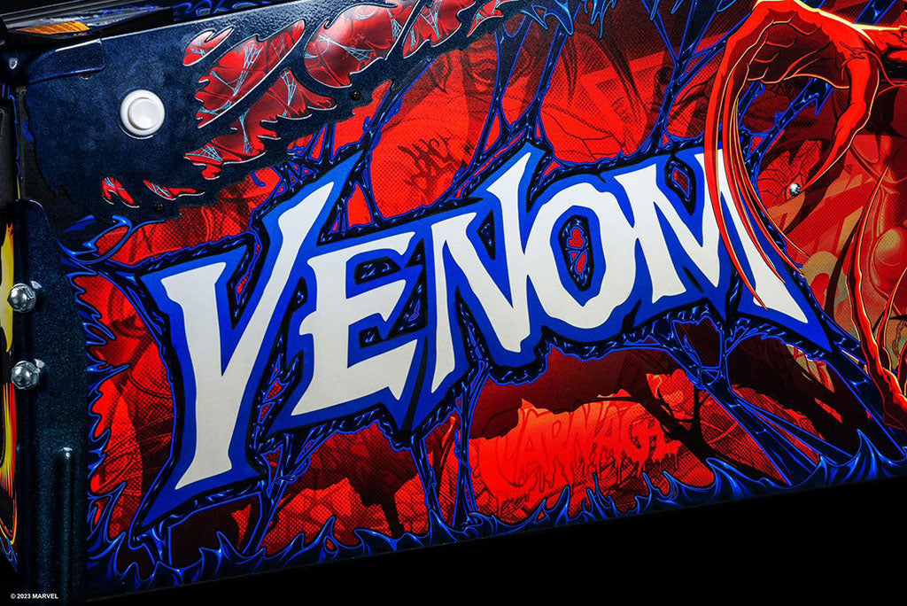 Close-up of a 'Venom' logo with red and blue design elements.