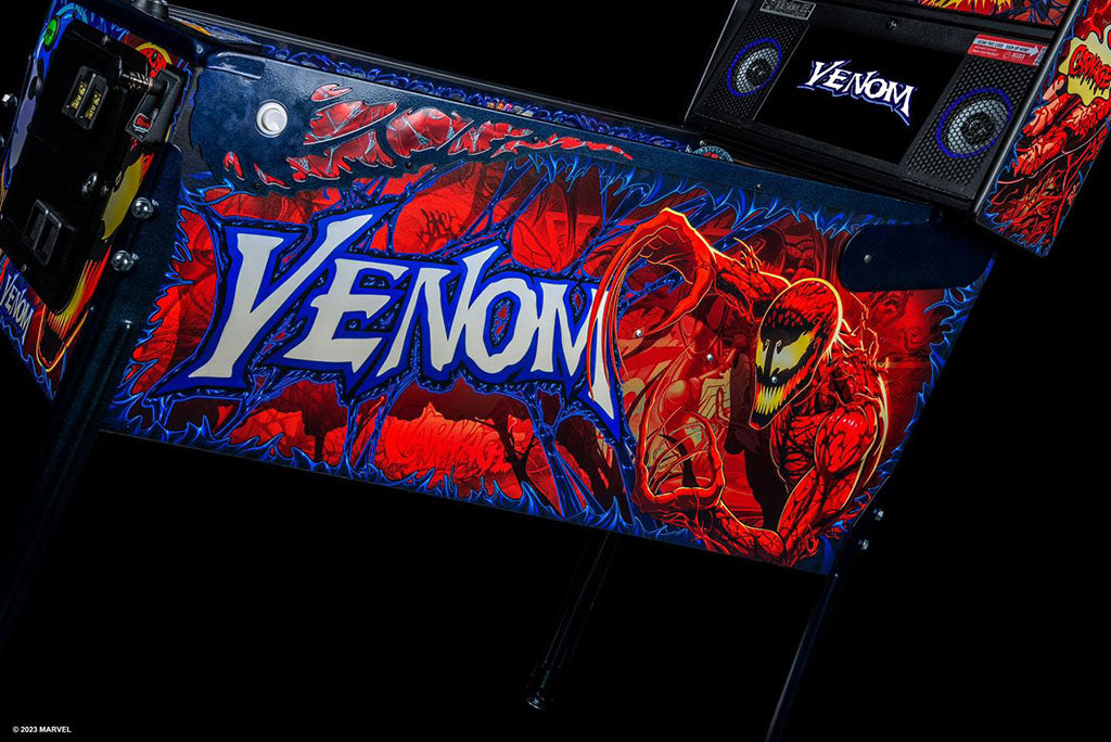 Venom-themed pinball machine with character design and 'Venom' branding.